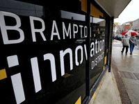 Pedestrians walk along Main Street in downtown Brampton, Ontario, Canada, on October 9, 2024, after a light rain. (