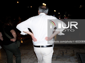 Tourists and locals spend their time at night in the center in Athens, Greece, on October 9, 2024. (