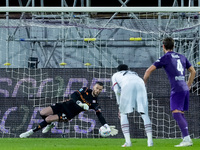 David De Gea of ACF Fiorentina saves on penalty kicked by Theo Hernandez of AC Milan during the Serie A Enilive match between ACF Fiorentina...