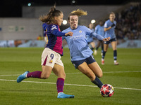 Lauren Hemp #11 of Manchester City W.F.C. tackles Claudia Pina #9 of FC Barcelona during the UEFA Women's Champions League Group D match bet...