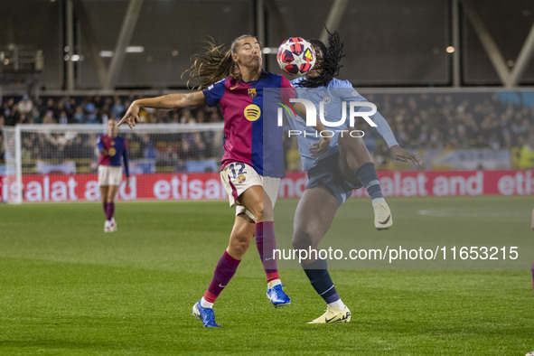 Patricia Guijarro #12 of FC Barcelona is tackled by Khadija Shaw #21 of Manchester City W.F.C. during the UEFA Women's Champions League Grou...