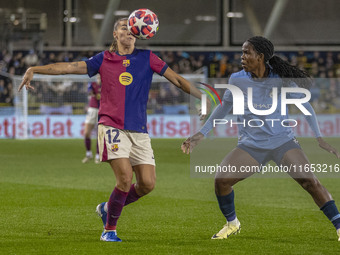 Patricia Guijarro #12 of FC Barcelona is tackled by Khadija Shaw #21 of Manchester City W.F.C. during the UEFA Women's Champions League Grou...