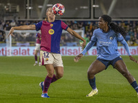 Patricia Guijarro #12 of FC Barcelona is tackled by Khadija Shaw #21 of Manchester City W.F.C. during the UEFA Women's Champions League Grou...