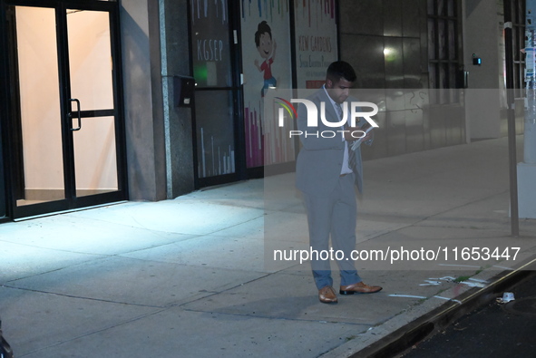 Detectives investigate the scene and search the area in the evening hours following a hate crime assault in front of Congregation B'Nei Abra...