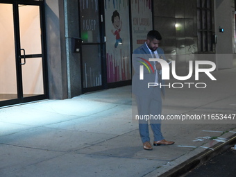 Detectives investigate the scene and search the area in the evening hours following a hate crime assault in front of Congregation B'Nei Abra...