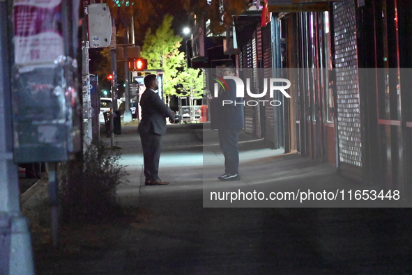 Detectives investigate the scene and search the area in the evening hours following a hate crime assault in front of Congregation B'Nei Abra...