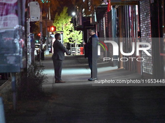 Detectives investigate the scene and search the area in the evening hours following a hate crime assault in front of Congregation B'Nei Abra...