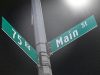 Street signage marks the location of the assault. Detectives investigate the scene and search the area in the evening hours following a hate...