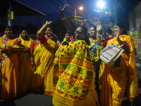 Devotees dance with a banana tree trunk during a ritual Nabapatrika as part of the Durga Puja festival in the early morning in Kolkata, Indi...