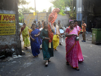 A lady carries a banana tree trunk during a ritual Nabapatrika as part of the Durga Puja festival in the early morning in Kolkata, India, on...