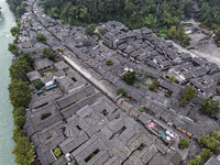 An aerial photo taken in Dujiangyan, China, on October 9, 2024, shows the ancient city complex of Guxian County in Dujiangyan City, Sichuan...