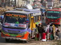 People board a bus as they return home for the fortnightly festival of Dashain in Kathmandu, Nepal, on October 10, 2024. (