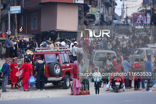 People wait for vehicles at the roadside as they prepare to return home for the fortnightly festival of Dashain in Kathmandu, Nepal, on Octo...