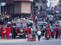 People wait for vehicles at the roadside as they prepare to return home for the fortnightly festival of Dashain in Kathmandu, Nepal, on Octo...