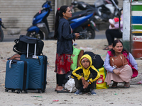 People wait for vehicles at the roadside as they prepare to return home for the fortnightly festival of Dashain in Kathmandu, Nepal, on Octo...