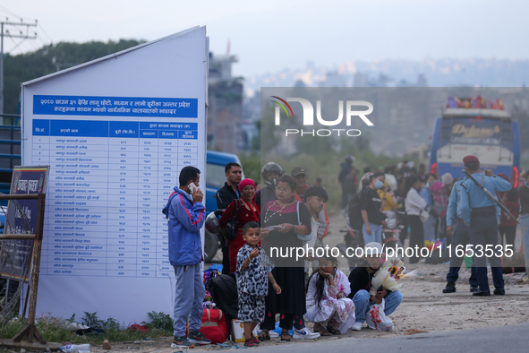 People wait for vehicles at the roadside as they prepare to return home for the fortnightly festival of Dashain in Kathmandu, Nepal, on Octo...