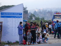 People wait for vehicles at the roadside as they prepare to return home for the fortnightly festival of Dashain in Kathmandu, Nepal, on Octo...