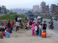 People wait for vehicles at the roadside as they prepare to return home for the fortnightly festival of Dashain in Kathmandu, Nepal, on Octo...