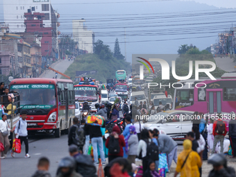 People wait for vehicles at the roadside as they prepare to return home for the fortnightly festival of Dashain in Kathmandu, Nepal, on Octo...