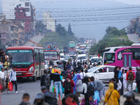 People wait for vehicles at the roadside as they prepare to return home for the fortnightly festival of Dashain in Kathmandu, Nepal, on Octo...