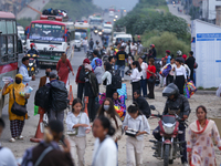 People wait for vehicles at the roadside as they prepare to return home for the fortnightly festival of Dashain in Kathmandu, Nepal, on Octo...