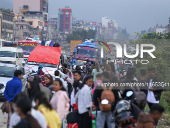 People wait for vehicles at the roadside as they prepare to return home for the fortnightly festival of Dashain in Kathmandu, Nepal, on Octo...