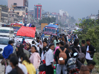 People wait for vehicles at the roadside as they prepare to return home for the fortnightly festival of Dashain in Kathmandu, Nepal, on Octo...