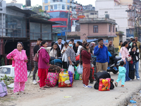 People wait for vehicles at the roadside as they prepare to return home for the fortnightly festival of Dashain in Kathmandu, Nepal, on Octo...