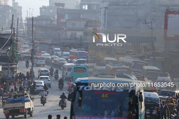 A vehicle departs from the capital, Kathmandu, covering a lane on a highway that leads out of the Kathmandu Valley in Kathmandu, Nepal, on O...