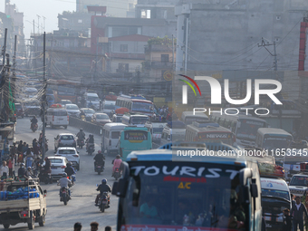 A vehicle departs from the capital, Kathmandu, covering a lane on a highway that leads out of the Kathmandu Valley in Kathmandu, Nepal, on O...