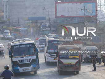 Vehicles depart from Kathmandu, Nepal, on October 10, 2024, as they ferry passengers out of the valley with the arrival of the fortnightly f...