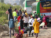 People wait for vehicles at the roadside as they prepare to return home for the fortnightly festival of Dashain in Kathmandu, Nepal, on Octo...