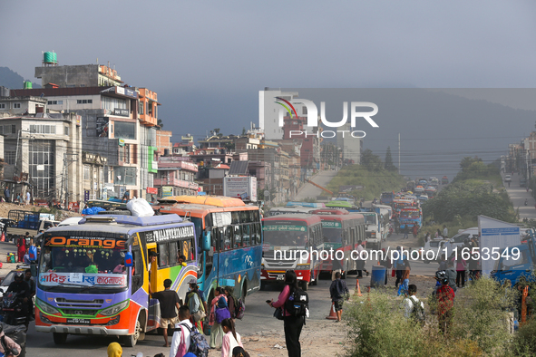 People wait for vehicles at the roadside as they prepare to return home for the fortnightly festival of Dashain in Kathmandu, Nepal, on Octo...