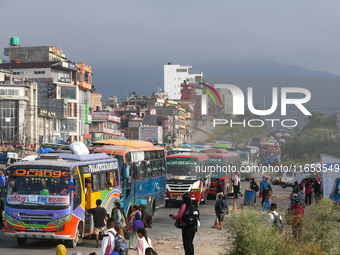 People wait for vehicles at the roadside as they prepare to return home for the fortnightly festival of Dashain in Kathmandu, Nepal, on Octo...