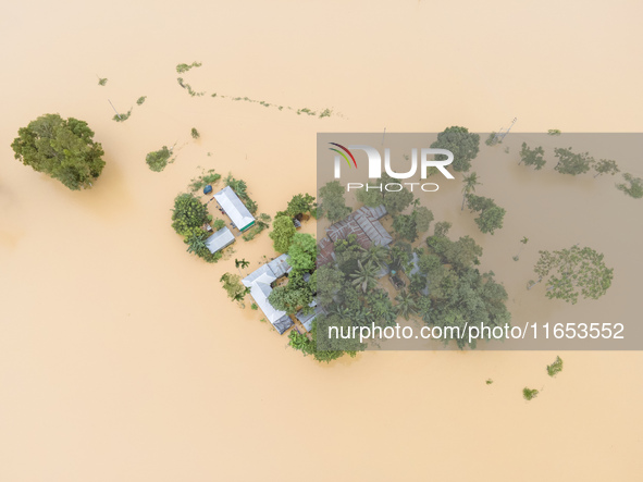 Heavy rains and water from upstream cause severe flooding in Sherpur, Bangladesh, on October 5, 2024, submerging houses. Seven deaths are re...