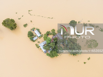 Heavy rains and water from upstream cause severe flooding in Sherpur, Bangladesh, on October 5, 2024, submerging houses. Seven deaths are re...