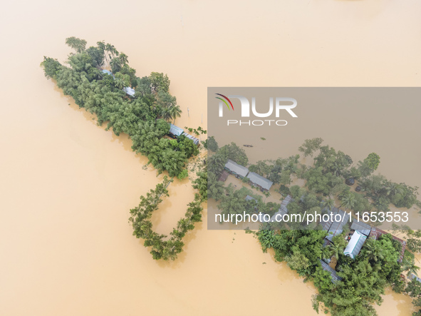 Heavy rains and water from upstream cause severe flooding in Sherpur, Bangladesh, on October 5, 2024, submerging houses. Seven deaths are re...