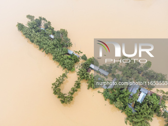 Heavy rains and water from upstream cause severe flooding in Sherpur, Bangladesh, on October 5, 2024, submerging houses. Seven deaths are re...