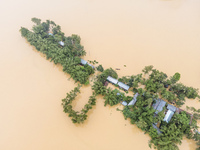 Heavy rains and water from upstream cause severe flooding in Sherpur, Bangladesh, on October 5, 2024, submerging houses. Seven deaths are re...