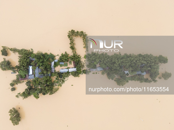 Heavy rains and water from upstream cause severe flooding in Sherpur, Bangladesh, on October 5, 2024, submerging houses. Seven deaths are re...