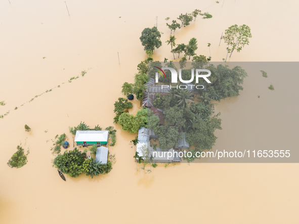 Heavy rains and water from upstream cause severe flooding in Sherpur, Bangladesh, on October 5, 2024, submerging houses. Seven deaths are re...