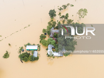 Heavy rains and water from upstream cause severe flooding in Sherpur, Bangladesh, on October 5, 2024, submerging houses. Seven deaths are re...