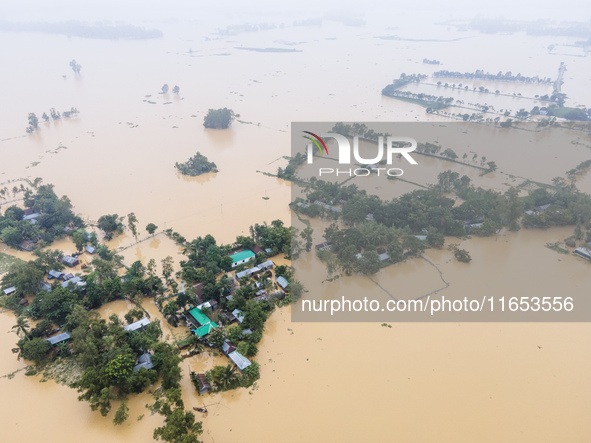 Heavy rains and water from upstream cause severe flooding in Sherpur, Bangladesh, on October 5, 2024, submerging houses. Seven deaths are re...