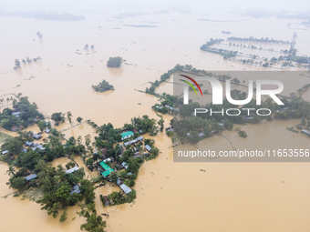 Heavy rains and water from upstream cause severe flooding in Sherpur, Bangladesh, on October 5, 2024, submerging houses. Seven deaths are re...