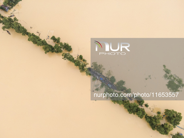 Heavy rains and water from upstream India submerge roads in a village in Jhenaigati upazila of Sherpur district in Sherpur, Bangladesh, on O...