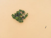 Heavy rains and water from upstream India submerge homes in a village in Jhenaigati upazila of Sherpur district, Bangladesh, on October 5, 2...