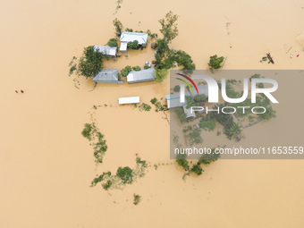 Heavy rains and water from upstream India submerge homes in a village in Jhenaigati upazila of Sherpur district, Bangladesh, on October 5, 2...