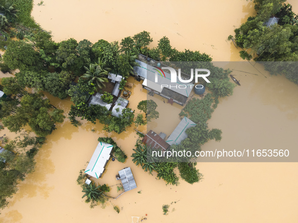 Heavy rains and water from upstream India submerge homes in a village in Jhenaigati upazila of Sherpur district, Bangladesh, on October 5, 2...