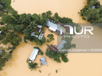 Heavy rains and water from upstream India submerge homes in a village in Jhenaigati upazila of Sherpur district, Bangladesh, on October 5, 2...