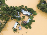 Heavy rains and water from upstream India submerge homes in a village in Jhenaigati upazila of Sherpur district, Bangladesh, on October 5, 2...